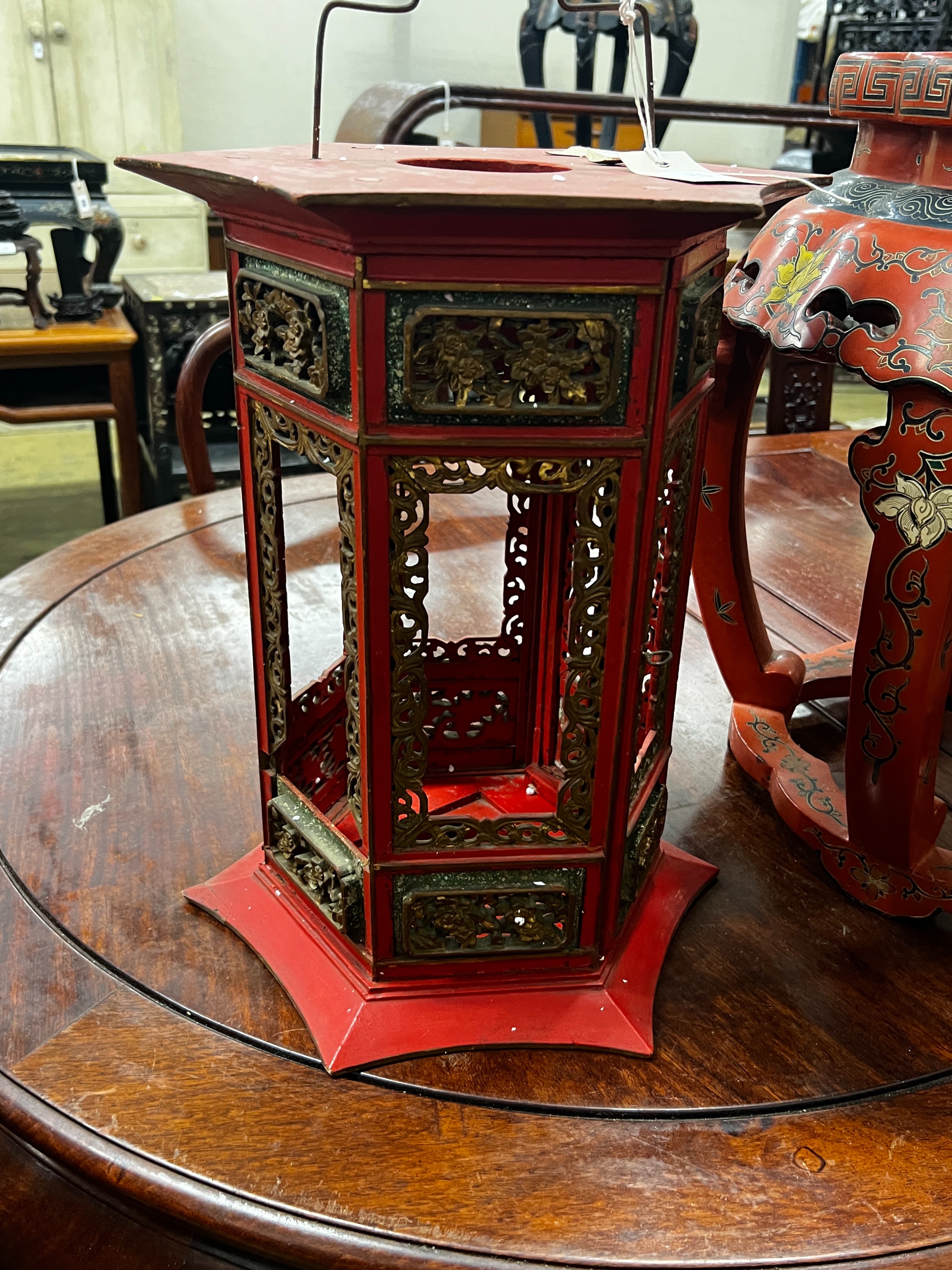 A Chinese red lacquer circular vase stand, diameter 44cm, height 47cm together with a similar Chinese red painted parcelgilt lantern, height 41cm